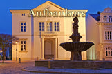 Neoclassical building with a fountain at night